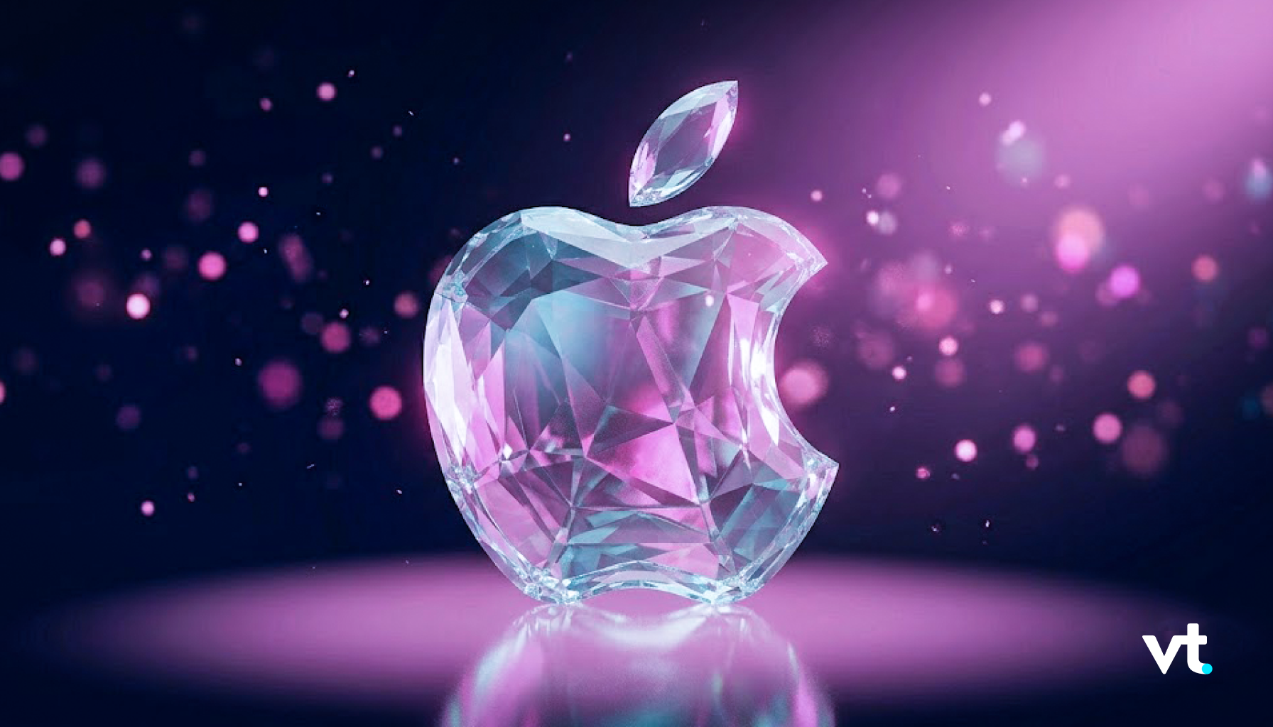 Faceted crystal Apple logo with a diamond-like surface, pink and blue glow, and a falling shard against a dark purple background (vt watermark in bottom-right).