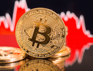 Gold Bitcoin coin in the foreground with a red financial chart in the background, signaling cryptocurrency trading.