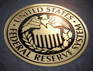 Gold circular seal of the United States Federal Reserve System featuring an eagle with a shield and laurel leaves.