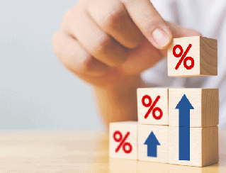 Hands stack wooden blocks with red % signs and blue upward arrows, signaling rising interest rates or growth in finance.