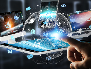 Hand pointing at a glowing globe surrounded by floating tablet and phone screens representing global digital connectivity.