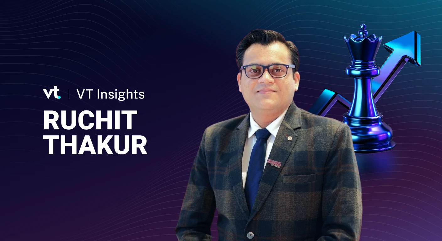 Portrait of Ruchit Thakur in a suit on a VT Insights banner with a blue chess king and rising arrow in the background.
