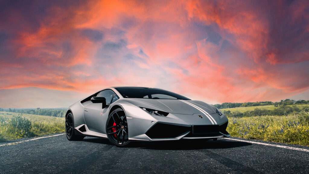 A picture of a Lamborghini set against a red sky.